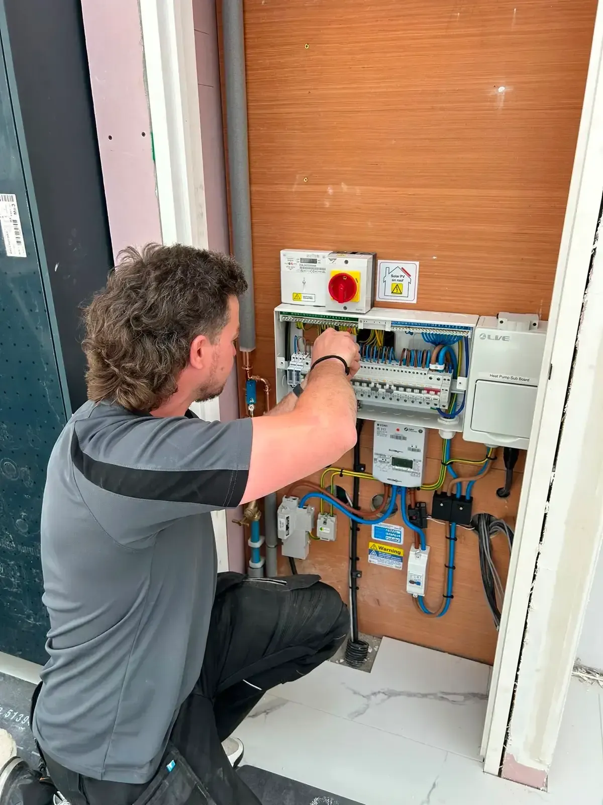 Culbertson engineer wiring a consumer unit on site